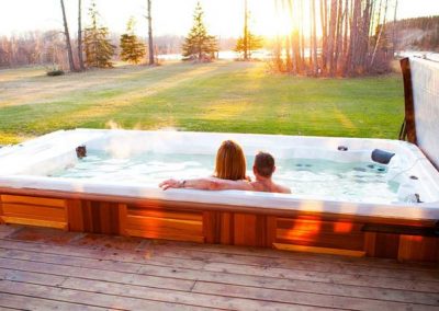 Couple looking at the sunset in the swim spa